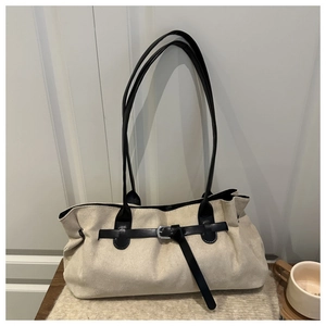 Off-white faux suede tote bag with black leather straps and metal buckle detailing