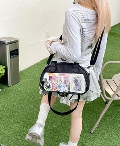 Detail of black ita bag with clear PVC window and adjustable strap for anime pins