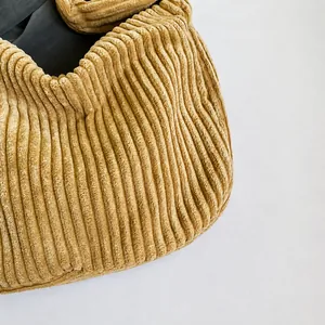 Close-up of high-quality khaki corduroy fabric with premium vertical striped texture