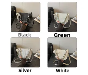Detail view of four color options for the lady's square handbag with pearl bow charm