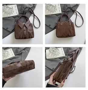 Detailansicht der braunen Beuteltasche mit kreativem Hemdkragen-Design und Metall-Reißverschluss
