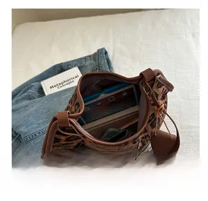 Detailed internal view of large leopard print bucket bag holding a tablet and notepad