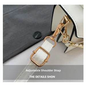 Detail of adjustable leather shoulder strap with gold-tone lobster clasp and black edge paint