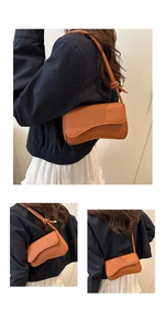 Detail van karamelbruine crossbodytas met asymmetrische flap en leer met litchi-textuur
