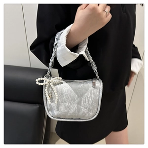 Silver metallic pleated handbag with chunky chain strap and pearl bow charm