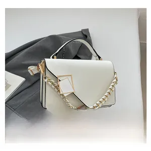 White crossbody bag featuring a gold chain strap and elegant rectangular metal buckle