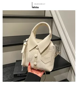 Detail of creative shirt-shaped bucket bag in beige with collar and button accents