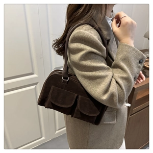 Detail showing deep brown suede tote bag with double front flap pockets and metallic zipper
