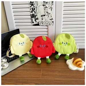 Detailed close-up of colorful cartoon fruit-shaped canvas bags in yellow, red and green