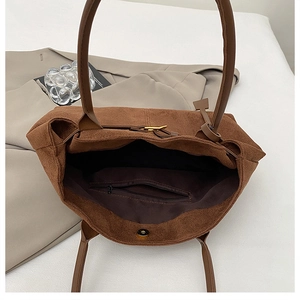 Detail view showing large interior space with zipper pocket and magnetic snap of tote bag