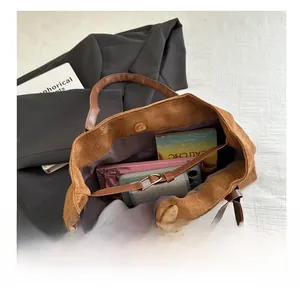 Interior view of brown suede tote bag showing large capacity for wallet and phone