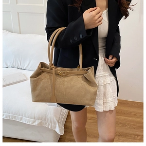 Khaki matte suede tote bag detail with fine leather strap and gold buckle adjustment
