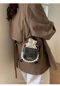 Chic snakeskin texture mini crossbody bag with pearl handle and silk drawstring detail