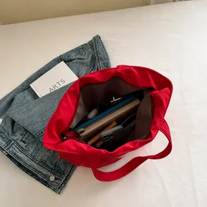 Interior view showing the large capacity and storage space of the red nylon tote bag