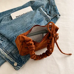 Brown corduroy tote bag showing large capacity space for phone and long wallet