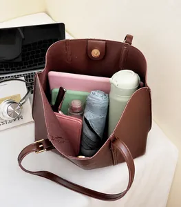 Interno di una borsa tote marrone scuro che mostra la grande capacità per oggetti quotidiani