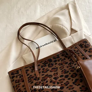 Detailed view of leopard print suede tote bag with matching pouch and brown leather trim