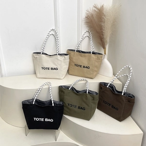 Canvas tote bags in five neutral colors featuring bold text and rope texture handles