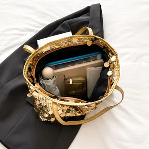 Detail view of large gold sequin tote bag interior showing spacious capacity for essentials