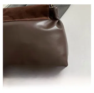 Detail of the brown leather and suede texture contrast on a stylish shoulder bag