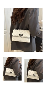 Dettagli di una borsa trapuntata bianca con chiusura in metallo e trama cucita elegante