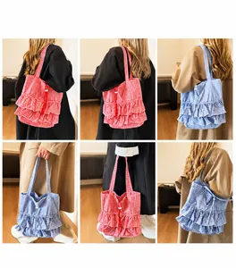 Detail view of plaid tote bag featuring decorative ruffles and drawstring closure