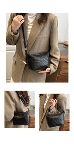 Detail of black woven crossbody bag featuring premium checkered leather texture and strap