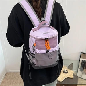 Outdoor lightweight purple hiking backpack with orange zippers shown on model's back