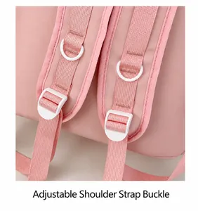 Detail of pink backpack shoulder strap with adjustable white plastic buckle and metal D-ring