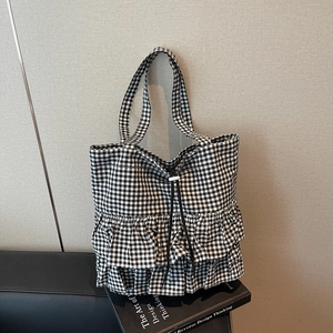 Fashionable black and white checkered tote bag with tiered ruffle pleats and drawstring