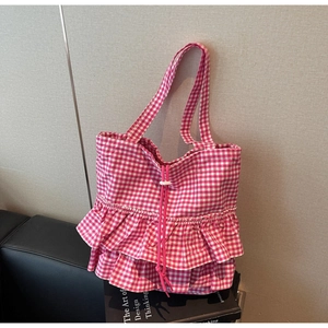 Pink and white checkered tote bag featuring stylish ruffled edges and drawstring closure