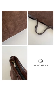 Detail of dark brown frosted leather tote bag showing smooth stitching and gold zipper