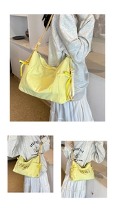 Detail of light yellow canvas tote bag with floral ribbon and letter embroidery
