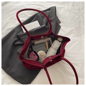 Top view of large burgundy suede tote bag showing internal capacity and magnetic closure