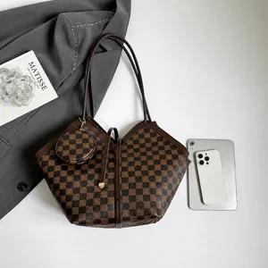 Detailweergave van grote geruite shopper met ronde portemonnee en accessoires