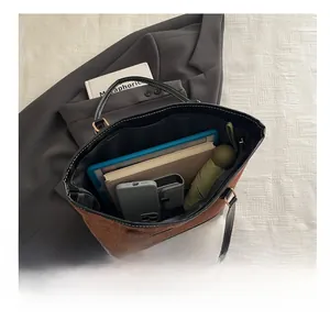 Macro view of large tote bag interior showing capacity for tablet, books and umbrella