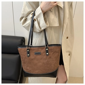 Detail of contrast-color tote bag with diamond quilting and FASHION logo on suede