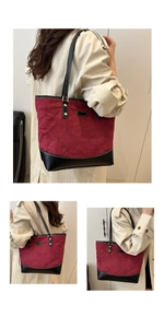 Detail of burgundy suede tote with quilted stitching and black leather trim accents