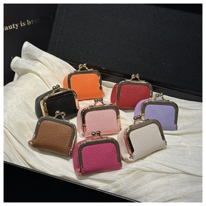 Macro detail of eight colorful lychee texture leather coin purses with gold metal kiss locks