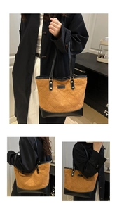 Close-up of brown quilted tote bag with diamond lattice pattern and fashion label