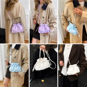 Quilted nylon bucket bags in purple, light blue and white showing drawstring closure detail