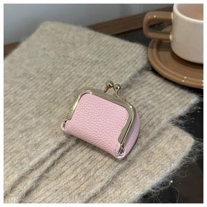 Mini light pink lychee pattern coin purse with gold frame on soft knitted blanket