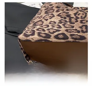 Detail of leopard print tote bag showing premium stitching and dark brown leather base