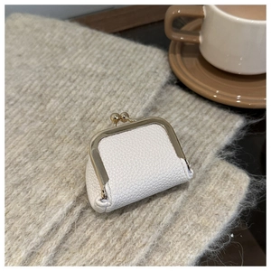 Mini cream litchi leather coin purse with vintage gold metal clasp on knit fabric