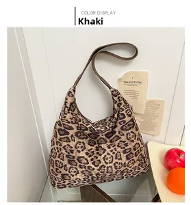 Close-up of leopard print tote bag in khaki fabric with brown leather shoulder straps