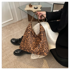 Macro shot of stylish leopard print fabric texture and wide shoulder strap on tote bag