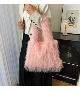 Pink faux fur tote bag styled with a beige blazer in a cozy minimalist indoor setting