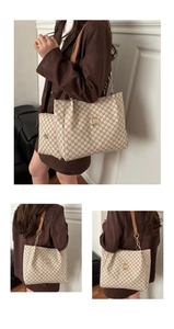 Close-up of beige tote bag set with all-over M print and metallic logo detail