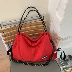 Bright red large capacity tote bag with woven straps and fashion patch details