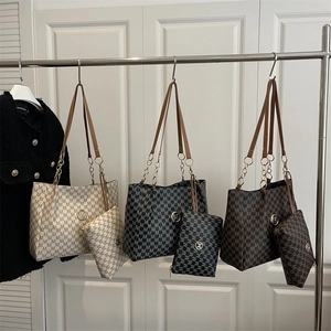 Three-color tote bag set with M-letter print and chain straps on minimalist background
